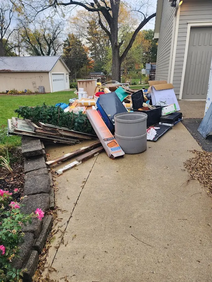 Dumpster being loaded with debris for Demolition Dumpster Rental in Crookston